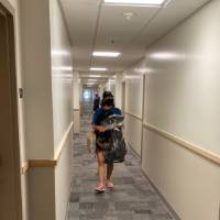 Sara Maas carries items into a residence hall